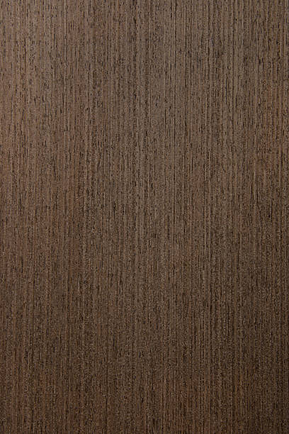 istock dark brown Wood Veneer showing grain detail 483372075