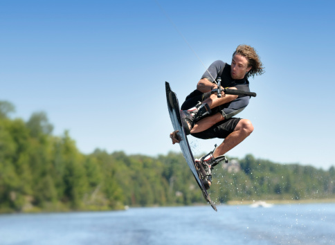 A young man in mid-air during a wakeboarding jump. Adobe RGB color profile.