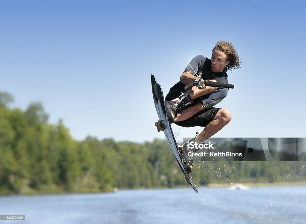 Wakeboarding A young man in mid-air during a wakeboarding jump. Adobe RGB color profile. Wakeboarding Stock Photo