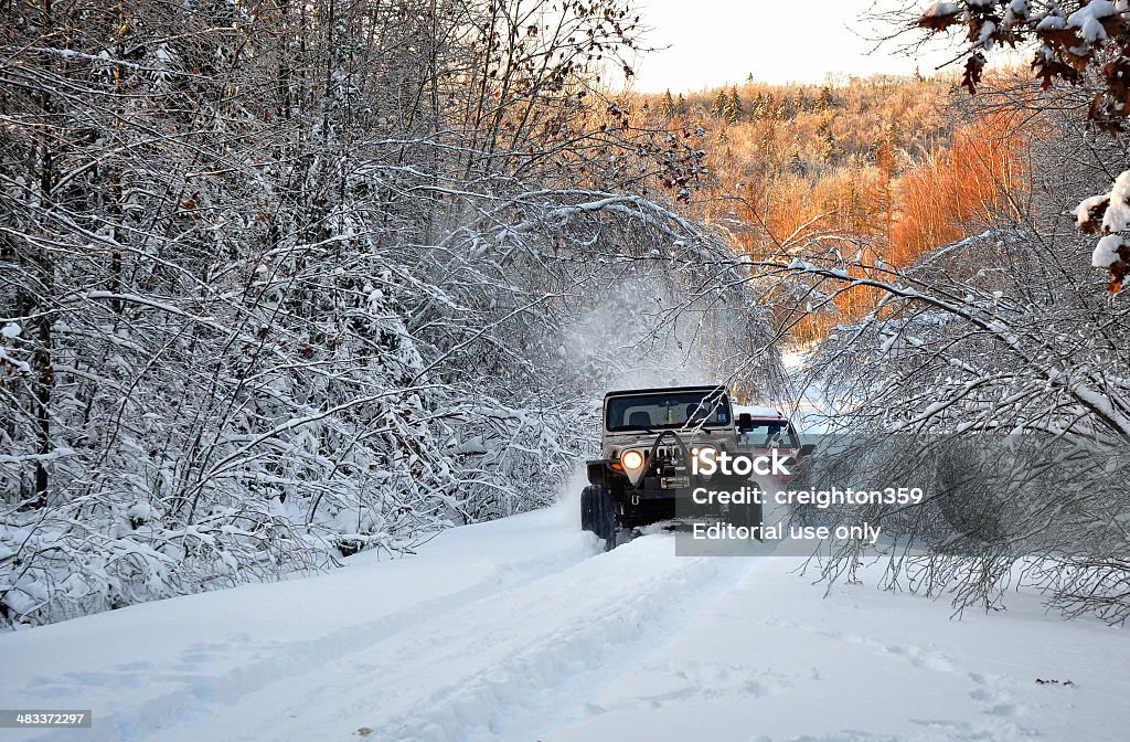 One Jeep Tows Out Another Stuck in Snow Springhill, Nova Scotia, Canada - January 5, 2014:  A Jeep tows out another Jeep that got stuck in deep snow. 4x4 Stock Photo