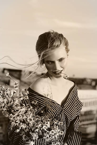 istock Blond woman  with chamomile flowers  Retro Style Image 483372306