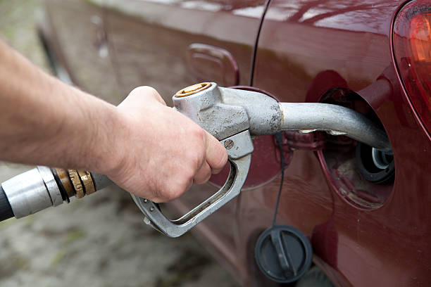 istock hand pumping gas in the car with a pump 483373765