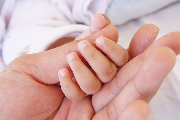 istock Hand of baby and father 483375061