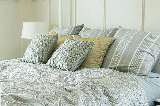 istock cozy bedroom interior with pillows and reading lamp 483375600
