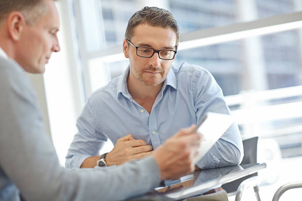 istock Businessmen with tablet during meeting 483376397