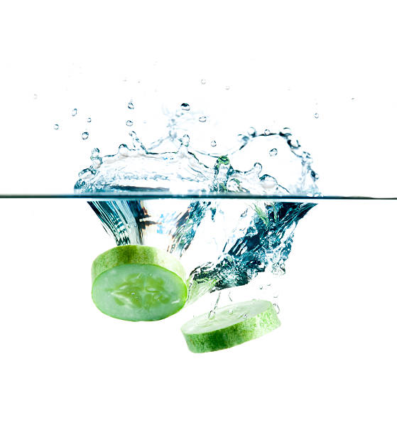 istock sliced cucumber splashing water isolated on white background 483376429
