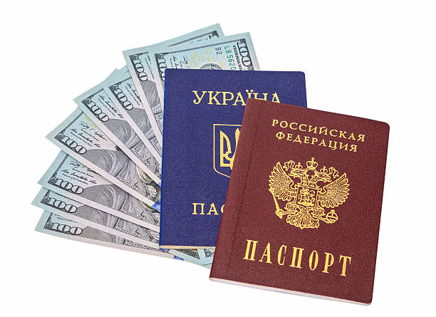 istock Ukrainian, Russian passports and  dollar bills over white backgr 483377009