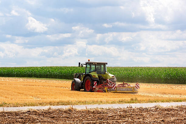 istock Agriculture - tractor ploughing at the field 483378004