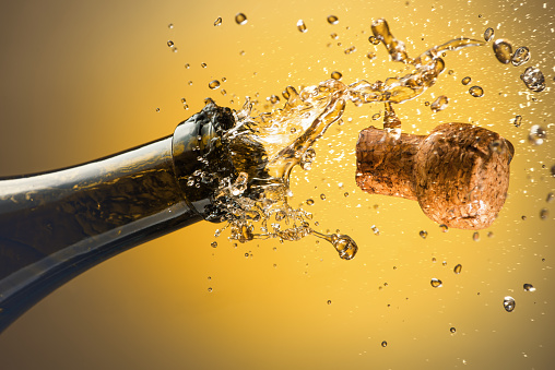 Opening a bottle of champagne. Celebration concept.
