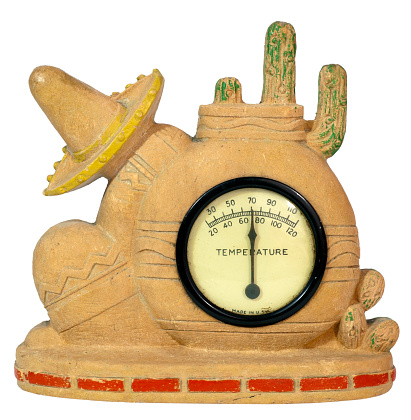 Vintage politically incorrect southwest desert scene USA souvenir thermometer. Aged and faded. The reading is stuck at 70 comfortable degrees. Isolated. White background. Horizontal.