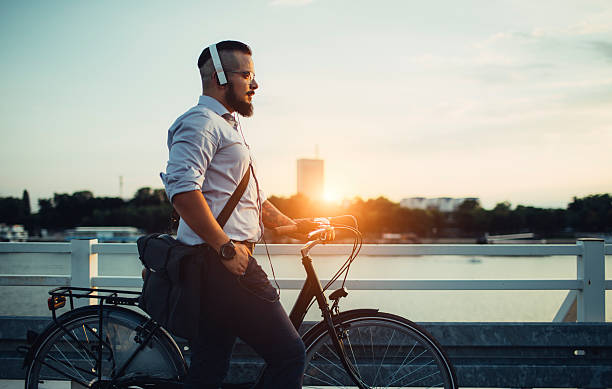 istock Businessman Pushing Bicycle and Listening Music. 483381018