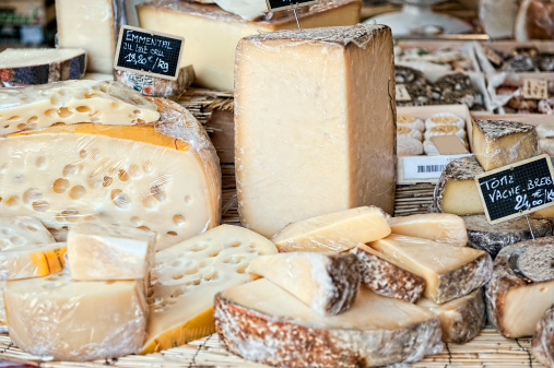 Variation of french cheese in market stall in Aix en Provence (France).