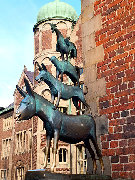 Bremen, Germany - May, 8 2013: Famous sculpture Bremer Stadtmusikanten  (The Town Musicians of Bremen - donkey, dog, cat and rooster). Sculptor  of monument The Town Musicians of Bremen is Gerhard Marcks (1889-1981). The sculpture was installed in 1951. 