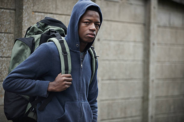 Homeless Teenage Boy On Streets With Rucksack Alone in the city hopelessness photos stock pictures, royalty-free photos & images