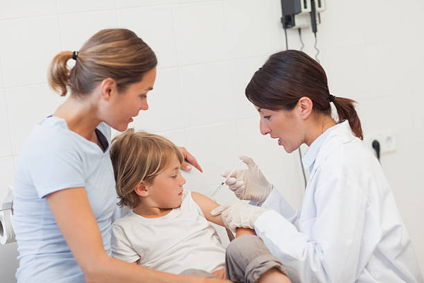 istock Child receiving an injection by a doctor 483395531