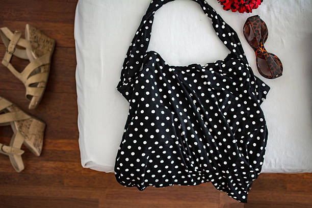 istock black polkadot halter dress on white bed linnen 483396816