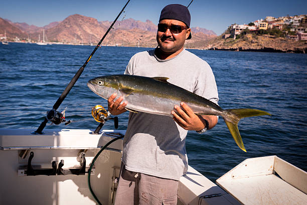 istock Hispanic Man in his 20s Holding Big Fish 483397755