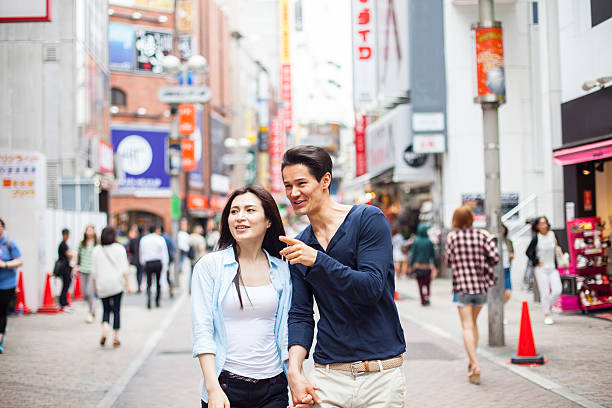 istock Young couple against cityscape background 483399582