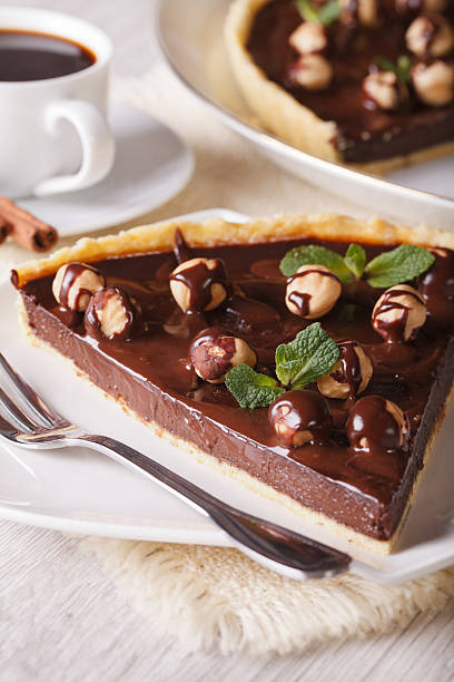 istock Chocolate tart with hazelnut and coffee close-up. Vertical 483402342