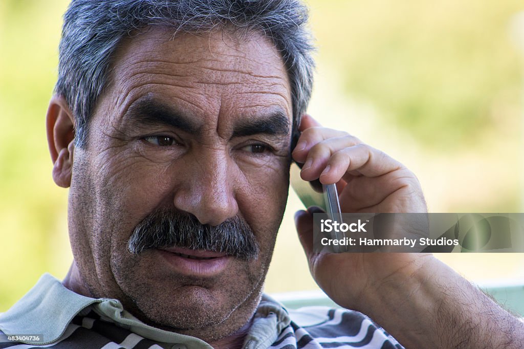Senior man talking on phone with shocked expression Senior man talking on phone with shocked expression. Shocked senior man listening phone and raising eyebrows. He is wearing casual clothes. Man sitting. Focus on shocked senior man. Horizontal composition. Image developed from Raw. Latin American and Hispanic Ethnicity Stock Photo