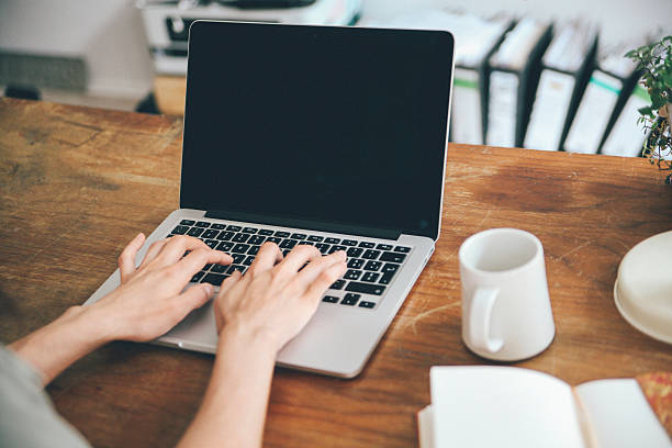 istock Female novelist writing on the laptop 483406486