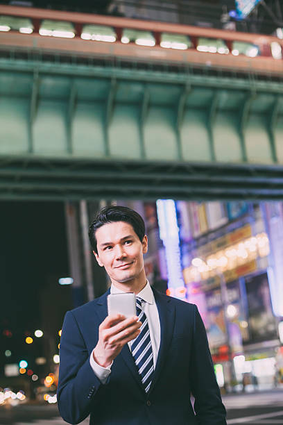 istock Asian businessman answering mobile phone 483410474