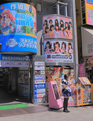 Tokyo Japan - May 22, 2015: Young girl promotes made cafe in cute costumen in Akihabara Tokyo Japan.