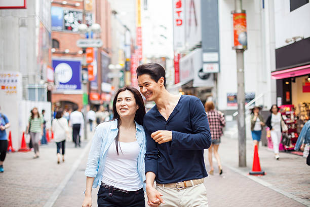 istock Young couple against cityscape background 483410532