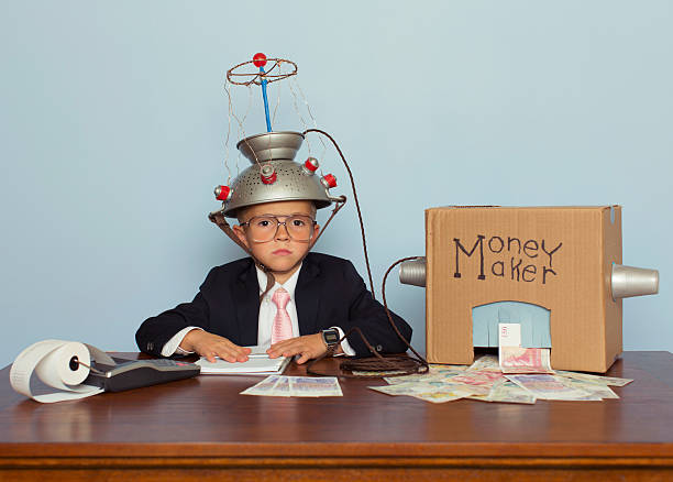 istock Young Boy Makes Money with Idea Helmet 483411934
