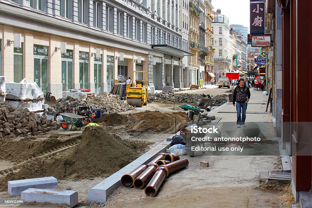 Street and sidewalk reconstruction. Brussels, Belgium - September 14, 2011: Street and sidewalk reconstruction in the process, pedestrians continue using sidewalk during reconstruction. Construction Worker Stock Photo