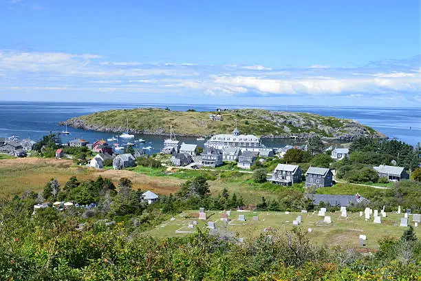 The populated area of Monhegan Island with Manana Island and the Island Inn as viewed from the lighthouse hill.