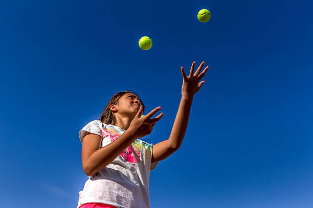 istock Looking up at girl juggling. 483413778