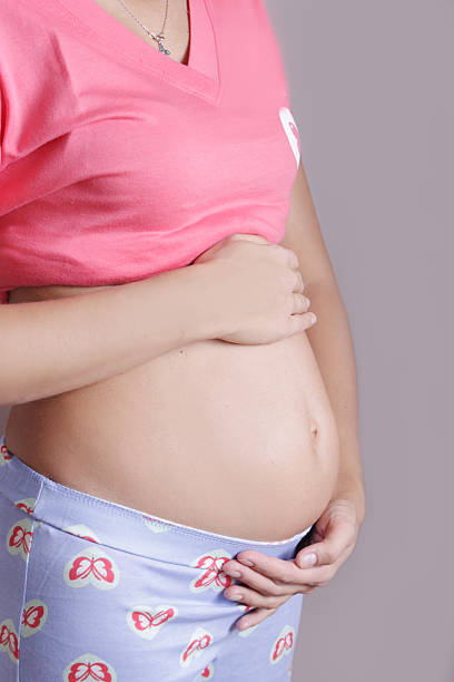 istock Pregnant woman holding her belly 483418076