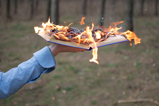 book on fire Burning book in a hand book burning photos stock pictures, royalty-free photos & images