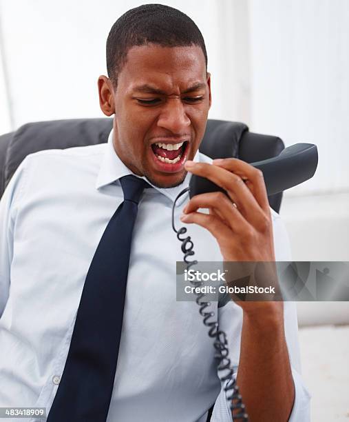 Businessman Shouting On Landline Phone Stock Photo - Download Image Now - African Ethnicity, African-American Ethnicity, Anger