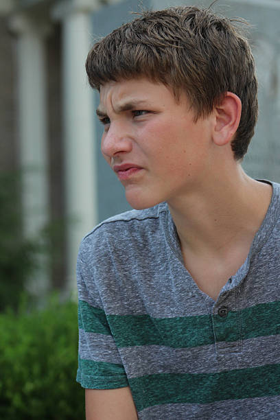 istock Teenager Squinting Eyes Has Frustrated Expression 483420964