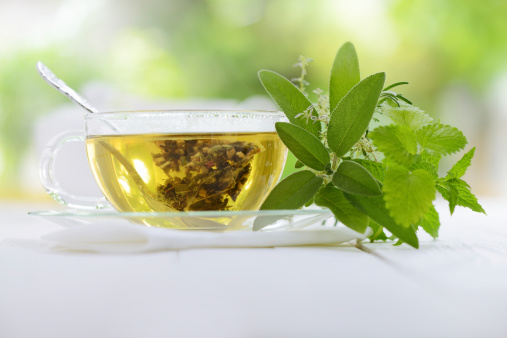 Herbal tea in a teabag with herbal leaves