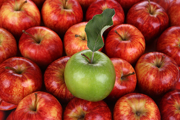 istock Green Apple on lots of Red 483421345