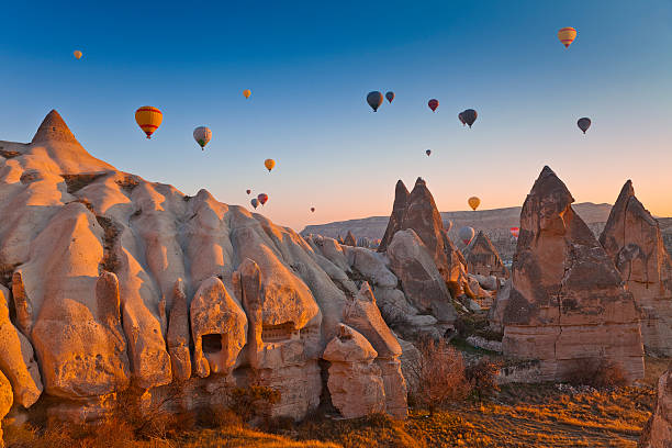 Cappadocia, Turkey Hot Air Balloons rise up over the Goreme Valley in Cappadocia, Turkey blowing photos stock pictures, royalty-free photos & images