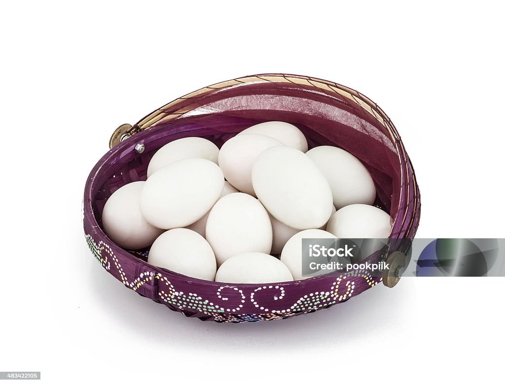 Eggs in violet basket on white background Animal Shell Stock Photo
