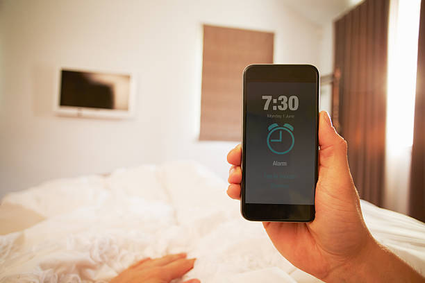 Person In Bed Turning Off Phone Alarm Point Of View Image Of Person In Bed Turning Off Phone Alarm alarm clock stock pictures, royalty-free photos & images