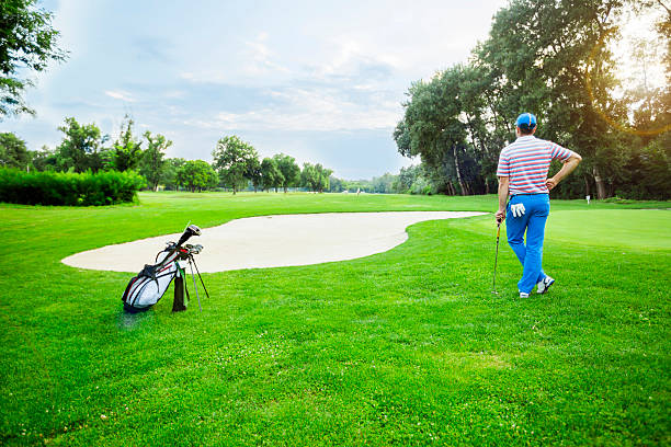 istock Beautiful golfing scenery with a golfer holding a club 483422500