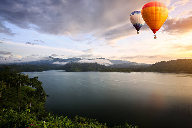 istock Hot air balloons floating over lake 483422675