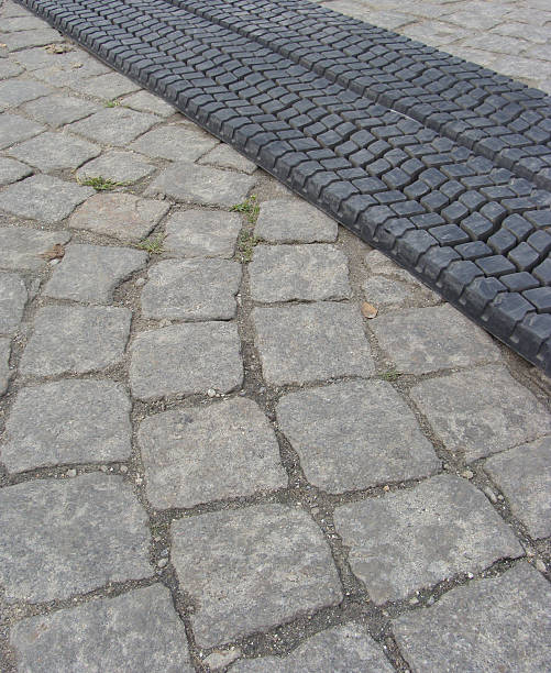 istock old tire rolled out on cobble-stone road 483423039