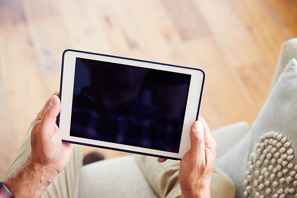istock Close Up Of Man Using Digital Tablet At Home 483423088
