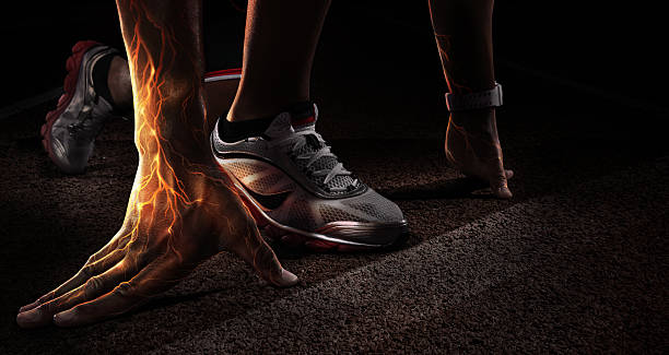 Sport. Runner. Hands on starting line. Fire and energy stock photo