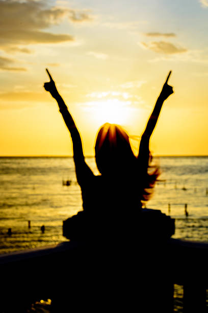 istock woman under the sunset at sea 483423188