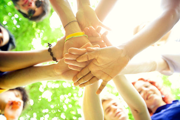 istock Group of people holding hands 483423425