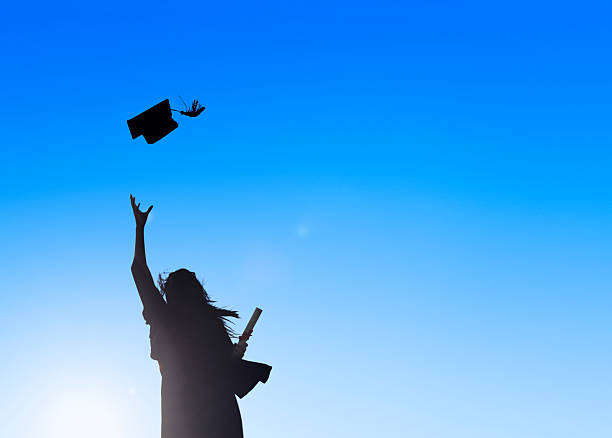Silhouette of Young Female Student Celebrating Graduation  mortarboard photos stock pictures, royalty-free photos & images