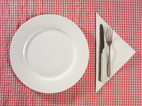 Place setting on a red Gingham tablecloth.
